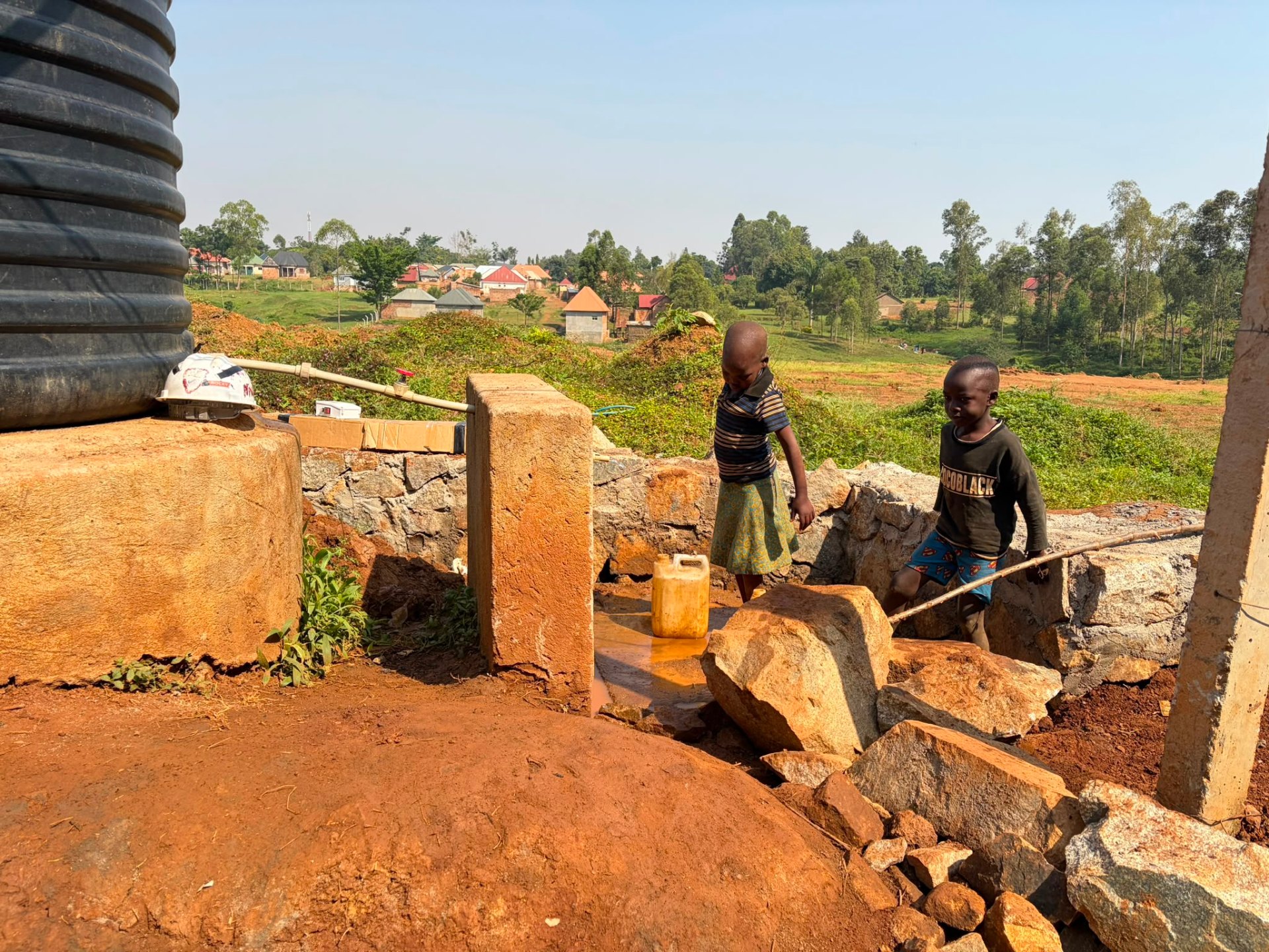 Burlcore water well construction in Mawero, Busia: Stone-lined catchment