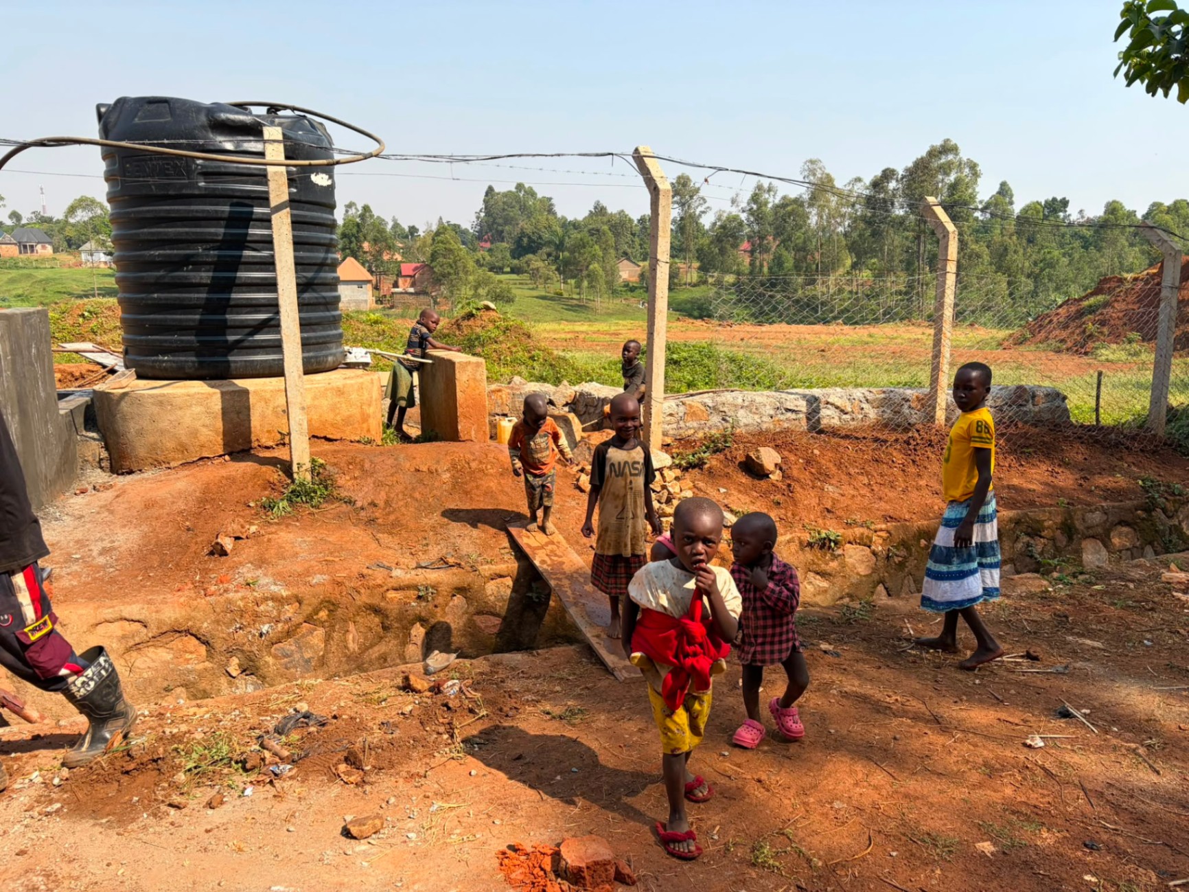 Children at the completed Burlcore-built water point in Mawero