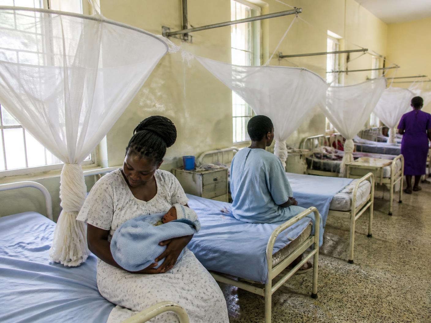 Mosquito nets fixed over maternity beds with fresh linen at Busia Health Centre IV